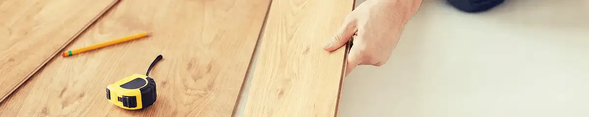 A professional installing wood flooring in Raleigh, NC