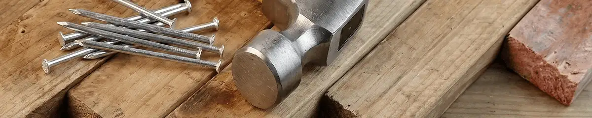 Hammer and nails on hardwood flooring boards in Raleigh, NC