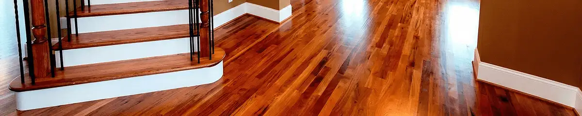 Base floor of a staircase with professionally restored wood flooring in Raleigh NC