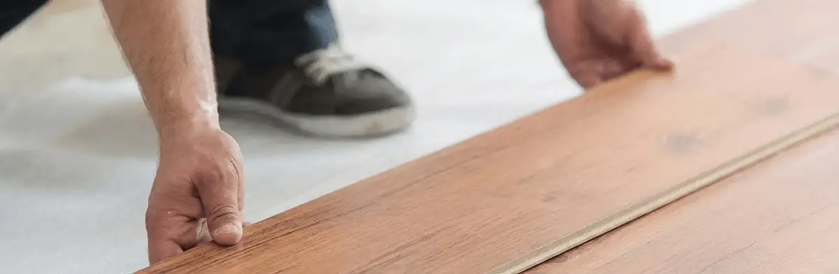A professional installing laminate flooring in Raleigh, NC