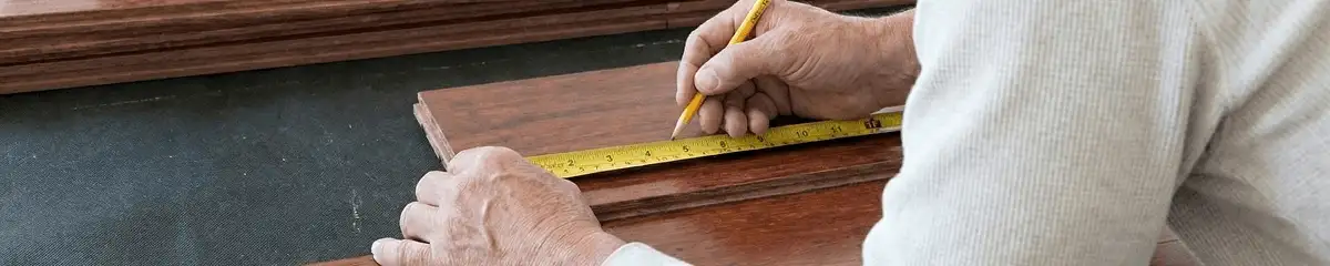 A professional installing wood flooring in Raleigh, NC